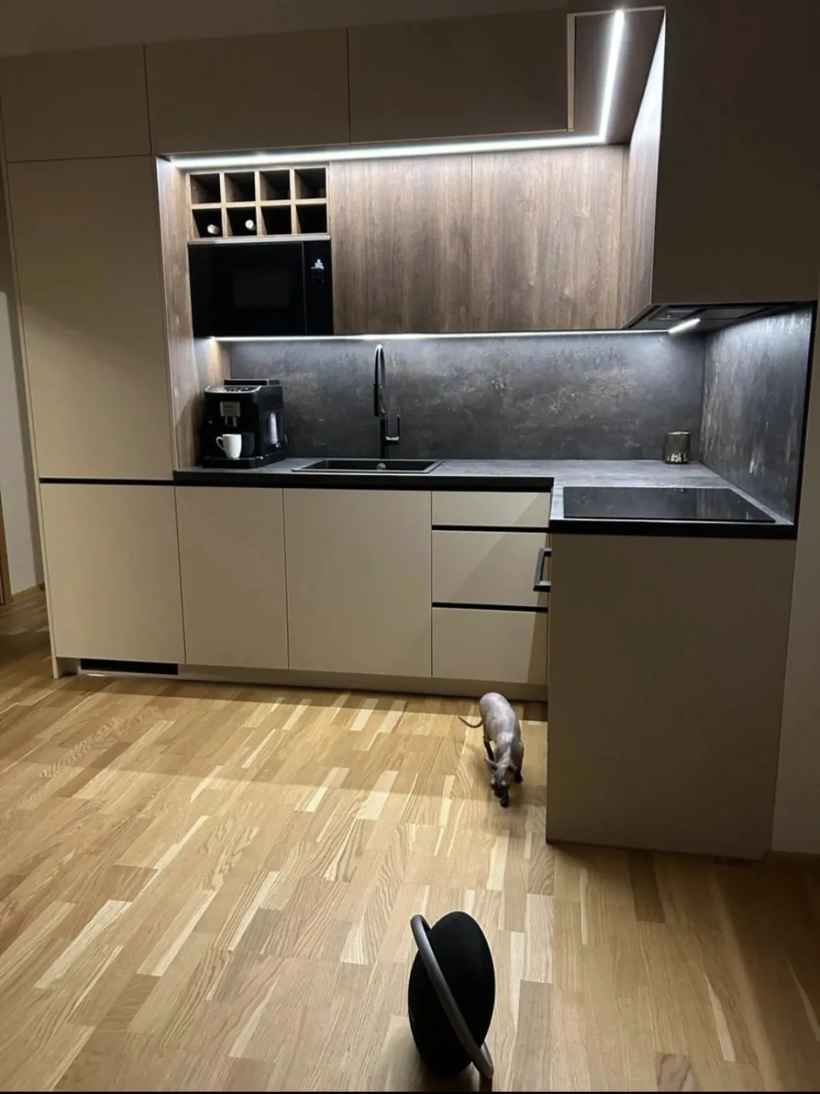 Completed compact kitchen with concealed LED lighting, integrated appliances and dark worktops in Dublin
