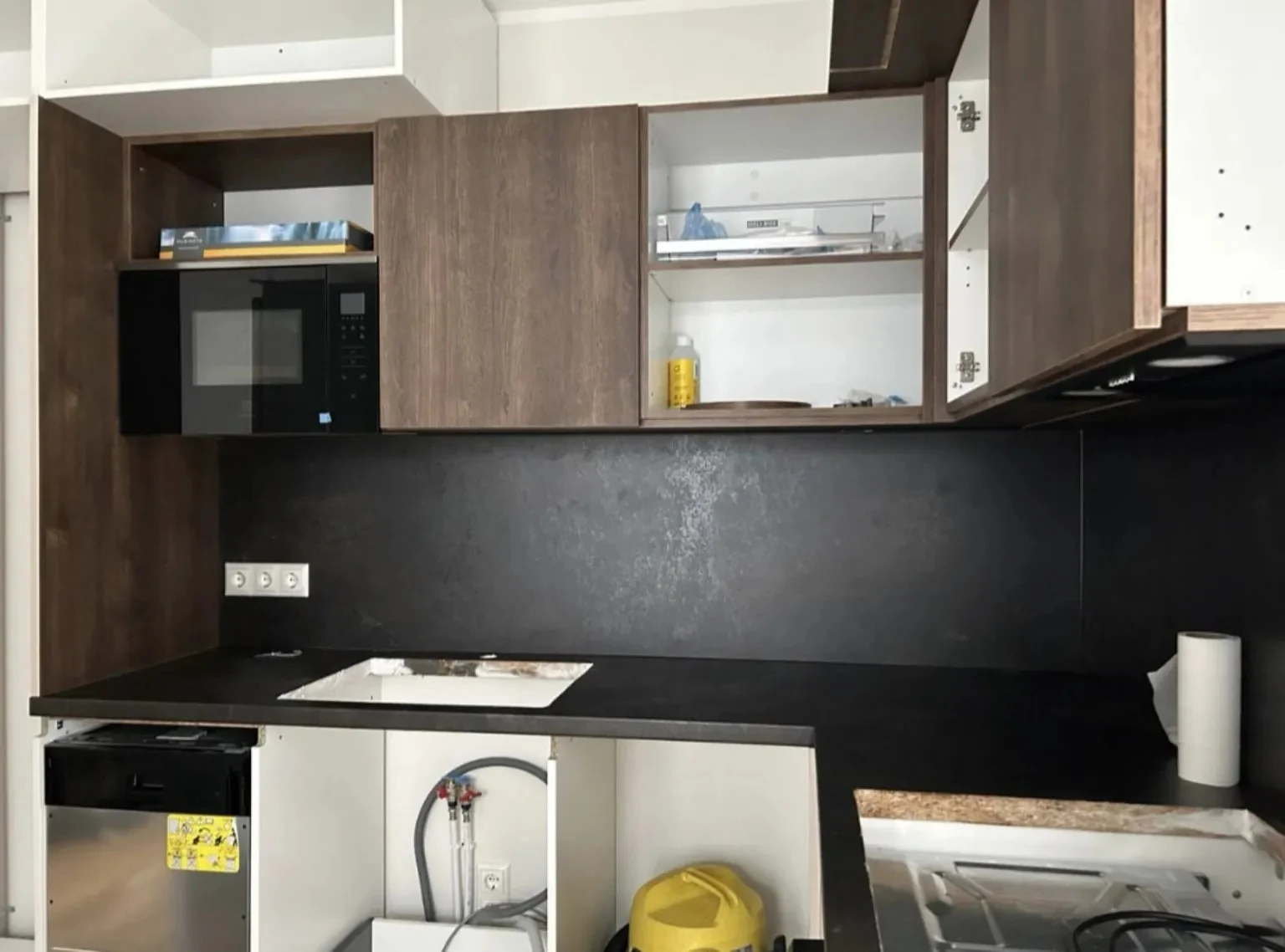 Kitchen cabinet fitting in progress with wall units, worktop opening and appliance spaces in Dublin