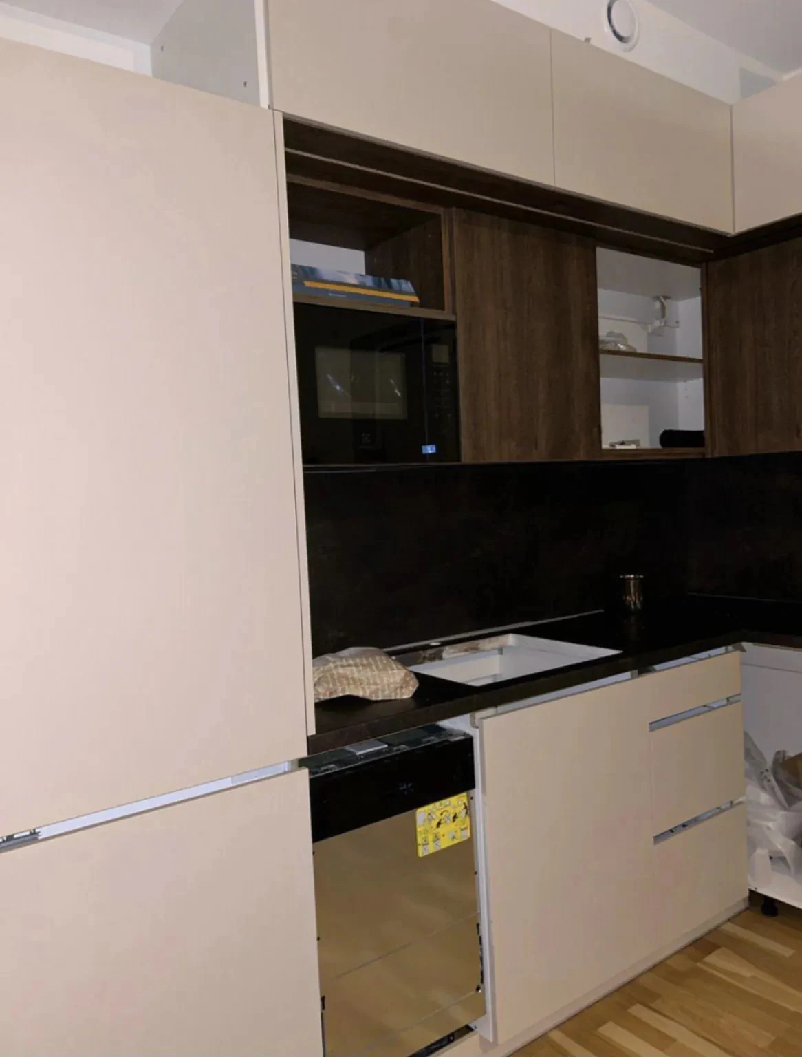 Kitchen fitting in progress with full-height cabinetry, built-in appliance and dark worktop in Dublin